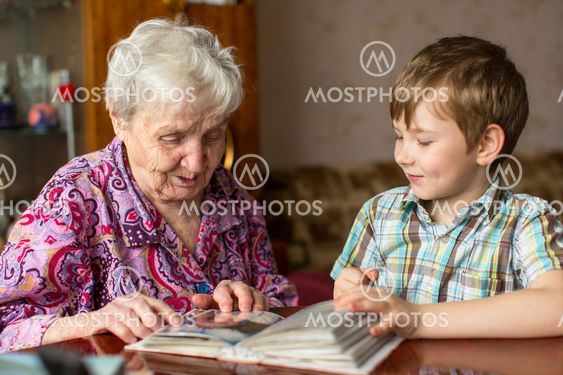 Grandmother and grandson looking photo album.
