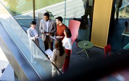 Group of professionals collaborating on project details...