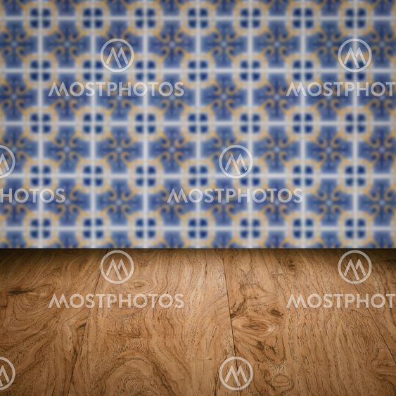 Wood table top and blur vintage ceramic tile pattern wall