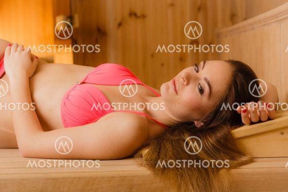 Portrait of woman relaxing in sauna. Spa wellbeing