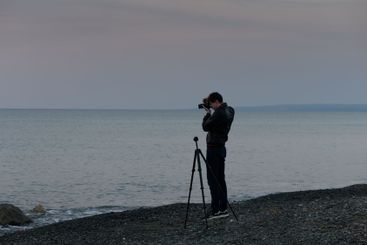 Capturing the tranquil beauty of dusk by the shore with...