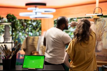 Diverse artists working on a new painting in workshop...