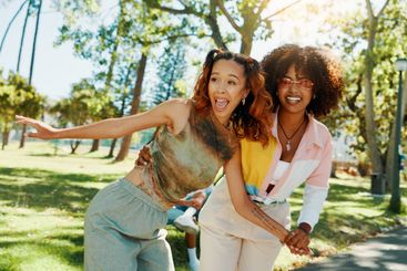 Women, friends and playful fun at park for social...