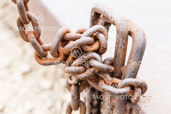 Old iron chain tie on the metal bar.
