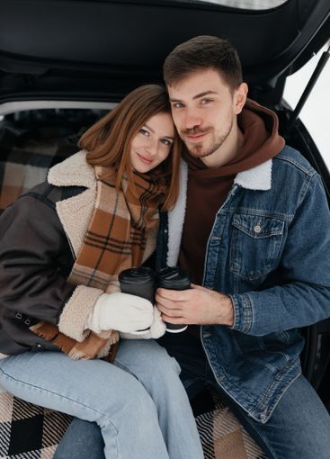 A Cozy Couple is Enjoying their Hot Beverages together...