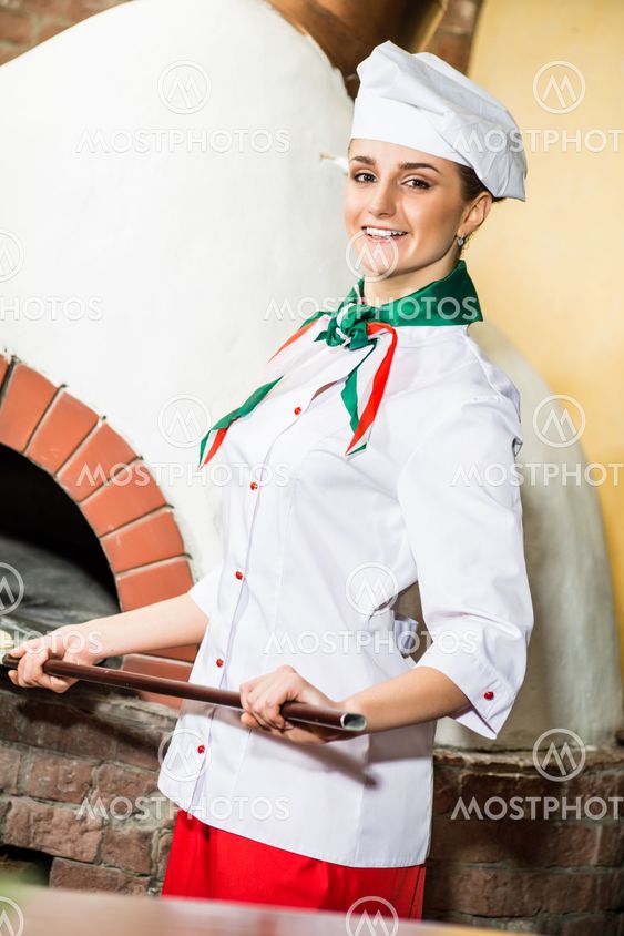 Chef puts dough in the oven for pizzas,