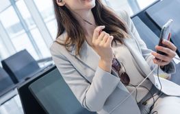 businesswoman doing a calls while at gate of airport