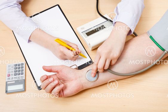 physician measures blood pulse of patient