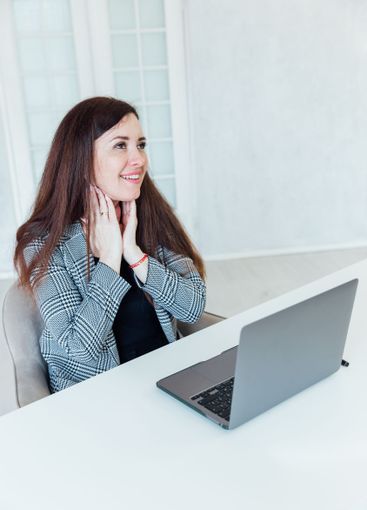 woman brunette sitting at table chatting online business