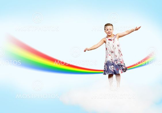 girl jumping on clouds and a rainbow