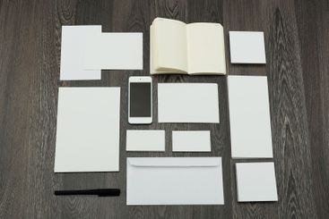 Workspace arrangement featuring blank stationery,...