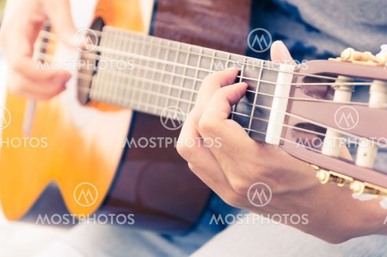 hand playing on guitar