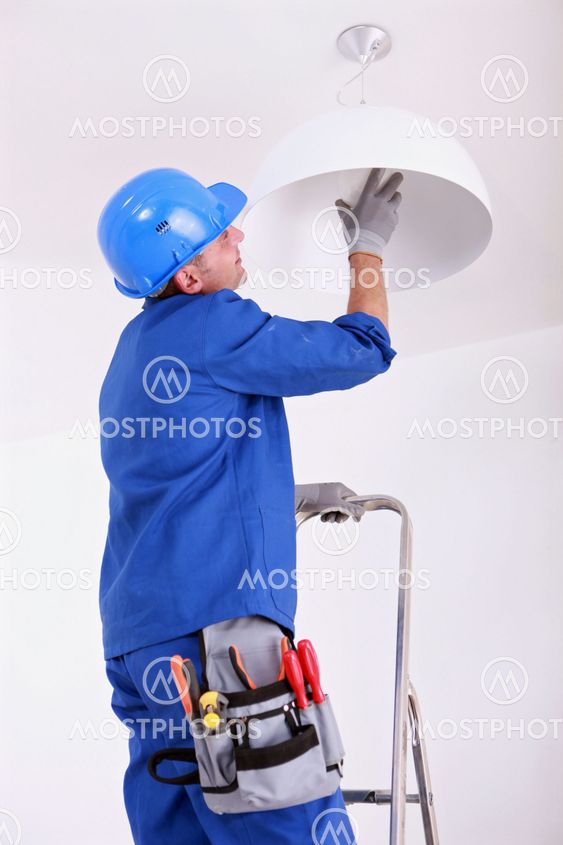 Electrician changing bulb