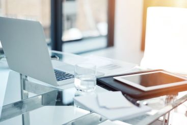 Empty office, technology and documents on desk in...