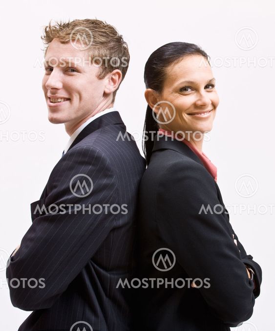 Business people standing back to back