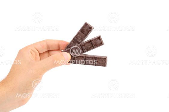 Hand holds three chocolate bars.