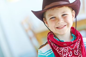 Happy, cowboy or child in portrait in home, childhood...