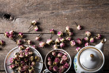 Vintage teapot and cup with blooming tea flowers on...