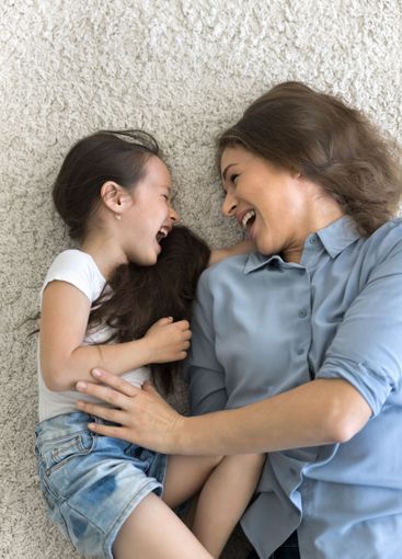 Active millennial mother little daughter playing...