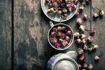Vintage teapot and cup with blooming tea flowers on...