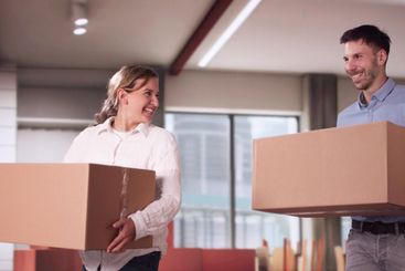 Happy Young Couple Moving Boxes