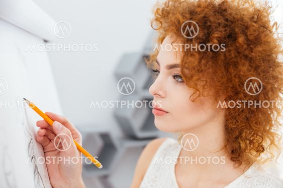 Concentrated attractive young woman fashion designer...