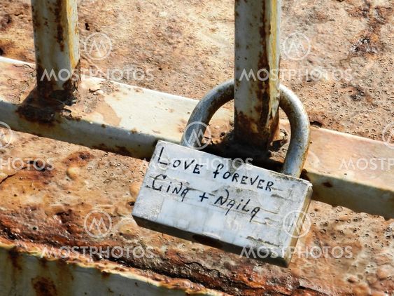 A padlock with caption "Love forever Gina+Naila" attached to the bars.