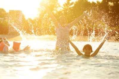 Happy children together splashing water