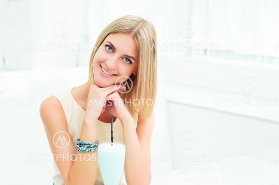 Portrait of a cute woman in a city cafe
