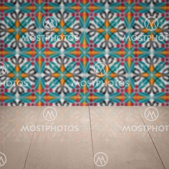 Wood table top and blur vintage ceramic tile pattern wall