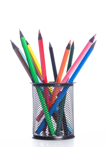 Colorful assortment of pencils in a metal holder on a...