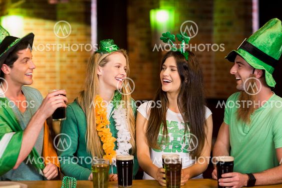 Smiling friends with Irish accessory