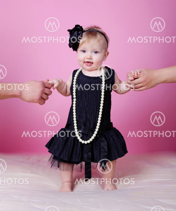Little girl in black dress in studio