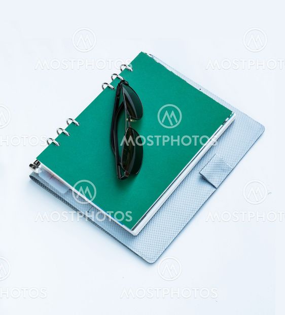 Sunglasses on a spiral notebook