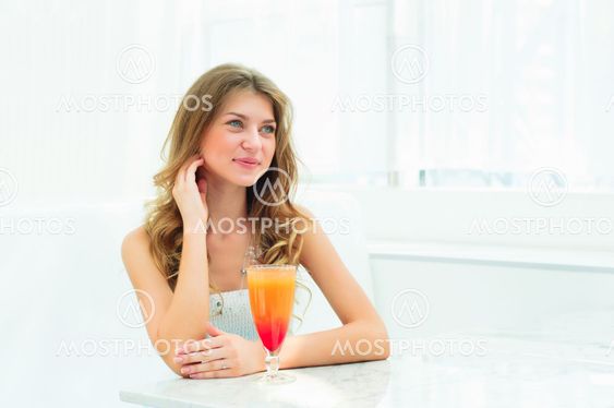 Portrait of a cute woman in a city cafe
