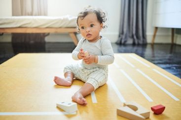 Baby boy, blocks and fun playing on floor in home,...