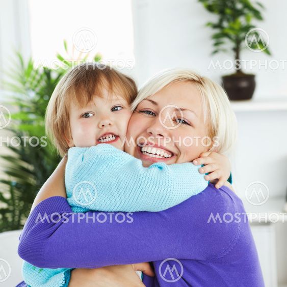 Attentive mother hugging her little daughter
