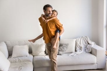 Father carrying his little 6s adorable daughter on his back
