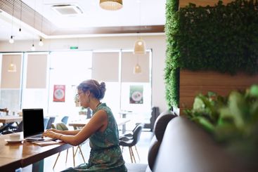 Cafe, businesswoman and laptop with typing for remote...