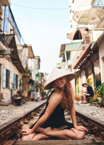Travel, happy and woman on railway for adventure,...