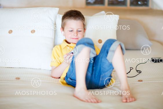 Boy playing video games on portable device