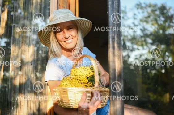 Happy smiling elderly woman having fun posing by open...