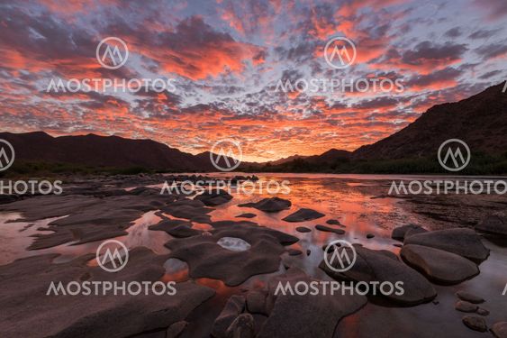 A beautiful landscape of a golden sunset over the...