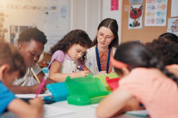 Writing, education and teacher helping children in...