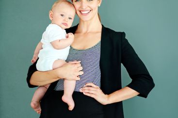 Businesswoman, baby and happy in studio for motherhood,...
