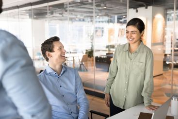 Happy young Indian business professional woman talking...