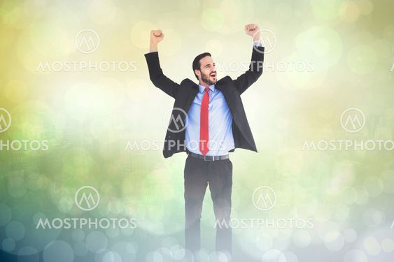 Composite image of happy cheering businessman raising his arms