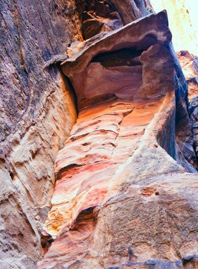 multicoloured sand rock cliffs above gorge Siq in Petra