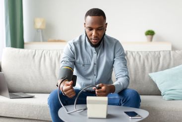 African American Young Man Measuring Arterial Blood...