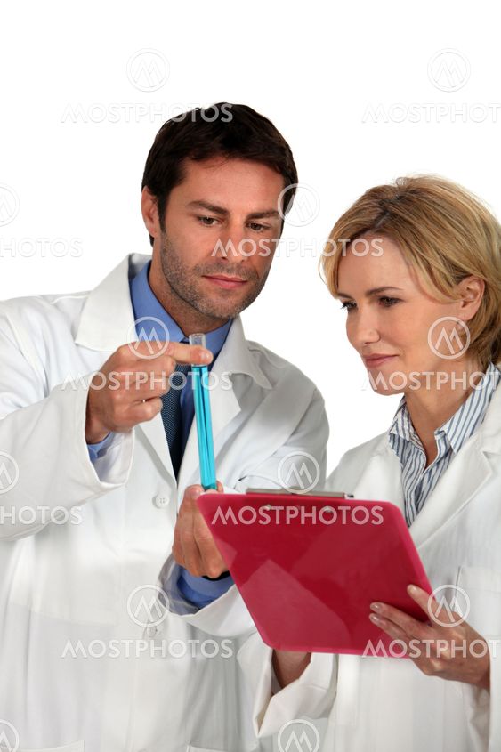 Couple of lab technicians examining test tube